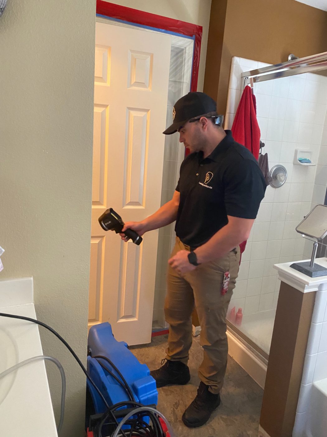 Leon technician scanning for moisture with a thermal camera